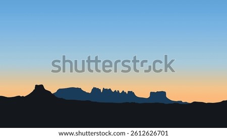 A serene and breathtaking view of the Big Bend National Park at dusk, with the rugged mountain silhouettes against a glowing, twilight sky.