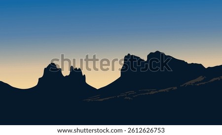 A serene and breathtaking view of the Big Bend National Park at dusk, with the rugged mountain silhouettes against a glowing, twilight sky.