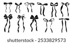 A series of black bows are shown in various positions. The bows are all different sizes and are arranged in a row. Concept of elegance and sophistication, as the bows are all neatly aligned