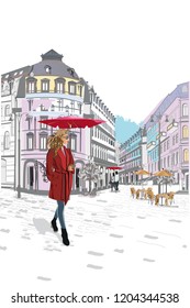 Series of the streets with fashion people in the old city. Beautiful woman in a red coat and an umbrella. 