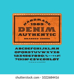 Serif font in the style of handmade graphics. Denim label for t-shirt design. Print on blue background