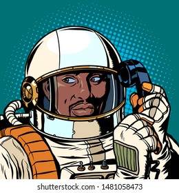 serious african astronaut talking on a retro phone. Pop art retro vector illustration drawing