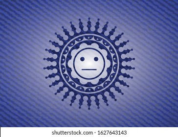 serious face icon inside badge with jean texture