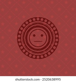 ícone de rosto sério dentro do crachá com fundo vermelho. 