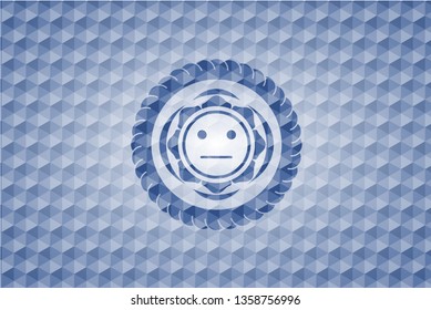 serious face icon inside blue emblem with geometric pattern.