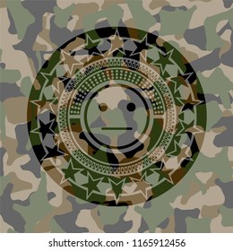 serious face icon inside camouflaged emblem