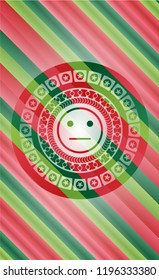 serious face icon inside christmas colors style badge.