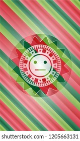 serious face icon inside christmas style badge..