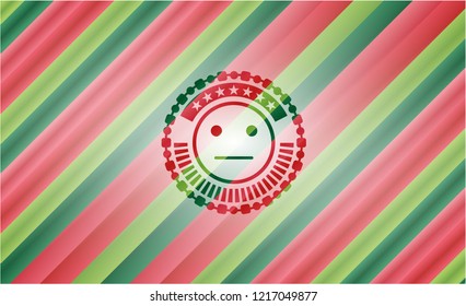 serious face icon inside christmas badge.