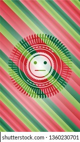 serious face icon inside christmas style badge..