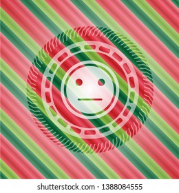 serious face icon inside christmas badge.