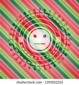 serious face icon inside christmas colors style emblem.