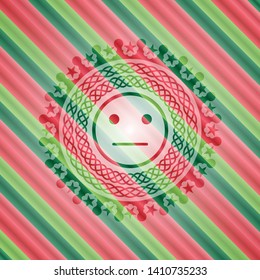 serious face icon inside christmas style badge..