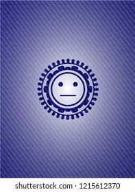 serious face icon inside emblem with denim texture