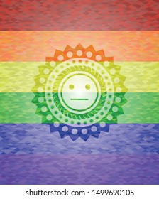 serious face icon inside emblem on mosaic background with the colors of the LGBT flag