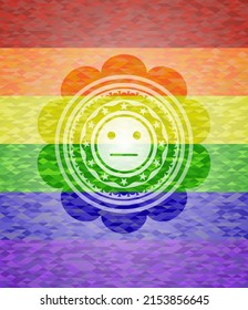 ernsthaftes Gesichtssymbol innerhalb des Emblems auf mosaikem Hintergrund mit den Farben der LGBT-Flagge. 