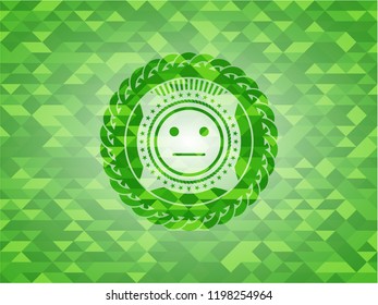 serious face icon inside green emblem. Mosaic background