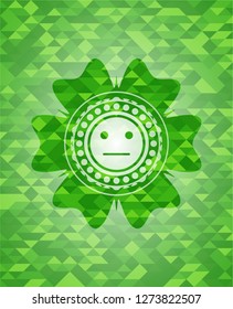 serious face icon inside green emblem with mosaic ecological style background