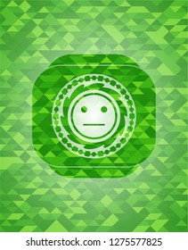 serious face icon inside green emblem with mosaic ecological style background