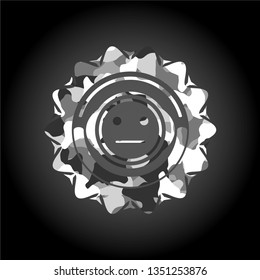 serious face icon inside grey camouflaged emblem