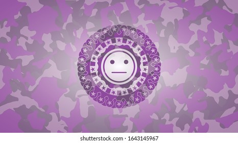serious face icon inside pink and purple camouflaged emblem
