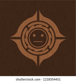 serious face icon inside realistic wooden emblem