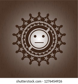 serious face icon inside realistic wood emblem