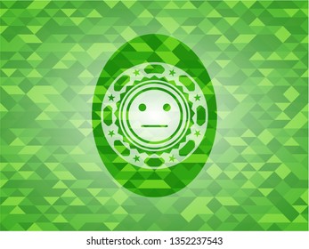 serious face icon inside realistic green mosaic emblem