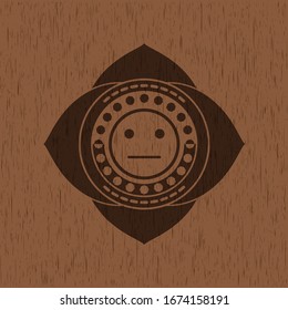 serious face icon inside realistic wooden emblem