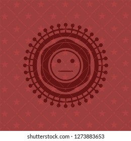 serious face icon inside red emblem