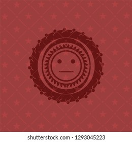serious face icon inside red emblem