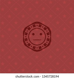 serious face icon inside red emblem
