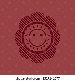 serious face icon inside red emblem
