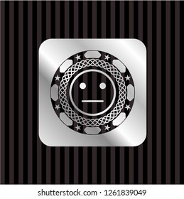 serious face icon inside silver emblem or badge