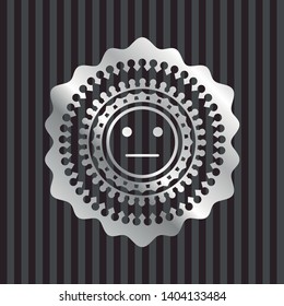 serious face icon inside silvery emblem or badge