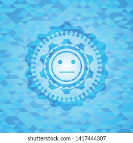 serious face icon inside sky blue emblem. Mosaic background
