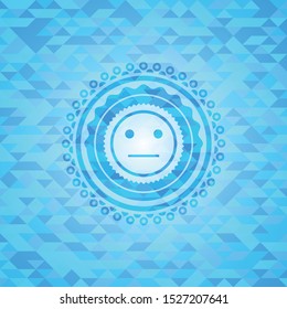 serious face icon inside sky blue emblem. Mosaic background