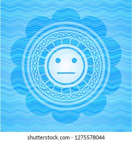 serious face icon inside water representation style emblem.