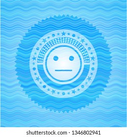 serious face icon inside water style badge.