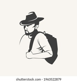 serious man with a beard and mustache in a hat with a backpack on his shoulder