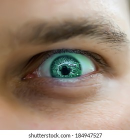 Serious sad and angry looking man with green eye. Vector