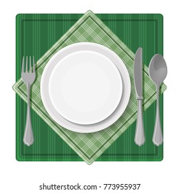 Served dinner plate with cutlery spoon fork and knife on green