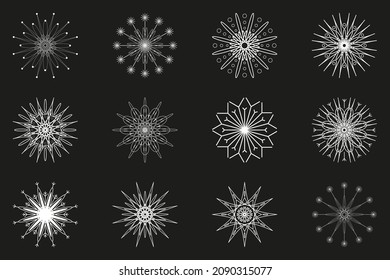Un conjunto de 12 copos de nieve blancos sobre un fondo gris oscuro. Un símbolo suave del invierno. Patrones de invierno abiertos.
