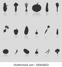 Set of 18 icons silhouettes of vegetables with reflection: corn, garlic, asparagus, broccoli, brussels sprout, cucumber, zucchini, celery, leek, eggplant, chili, pod beans, tomato, onion and pumpkin.
