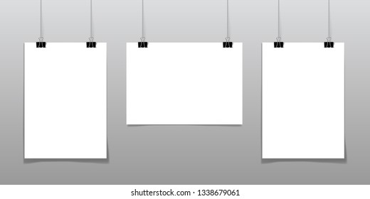 Set of 2 blank posters hanging on a thread with black clipsagainst a wall as a minimalistic style portfolio, gallery presentation concept. 3d illustration