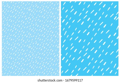 Set of 2 Cute Abstract Geometric Vector Patterns. White Irregular Brush Spots on a Light Blue Background. Lovely Pastel Color Delicate Layouts. Funny Infantile Style Vector Print.