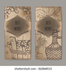 Set of 2 vintage wine label templates with grapes in wooden bucket and bottle in wicker case. Placed on old paper background. Great for wineries, grocery stores, wine label design. 