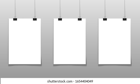 Set of 3 blank posters hanging on thread with clips