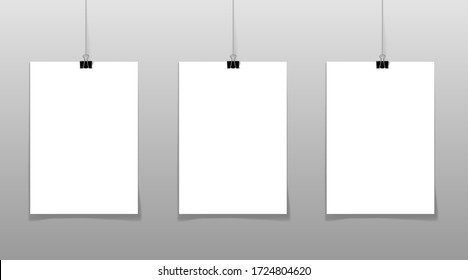 Set of 3 blank posters hanging on thread with clips