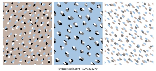 Set of 3 Cute Abstract Dots Vector Pattern. White, Black and Light Brown Irregular Brush Dots on a White, Beige and Blue Backgrounds. Lovely Pastel Color Delicate Layouts. Abstract Wild Animal Skin.